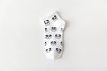 White sock with black panda pattern on a white background