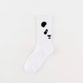 White sock with black abstract designs on a light gray background