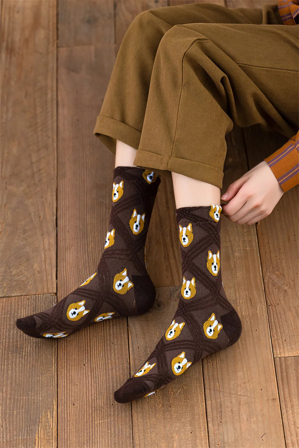 Person wearing brown socks with fox pattern on a wooden floor